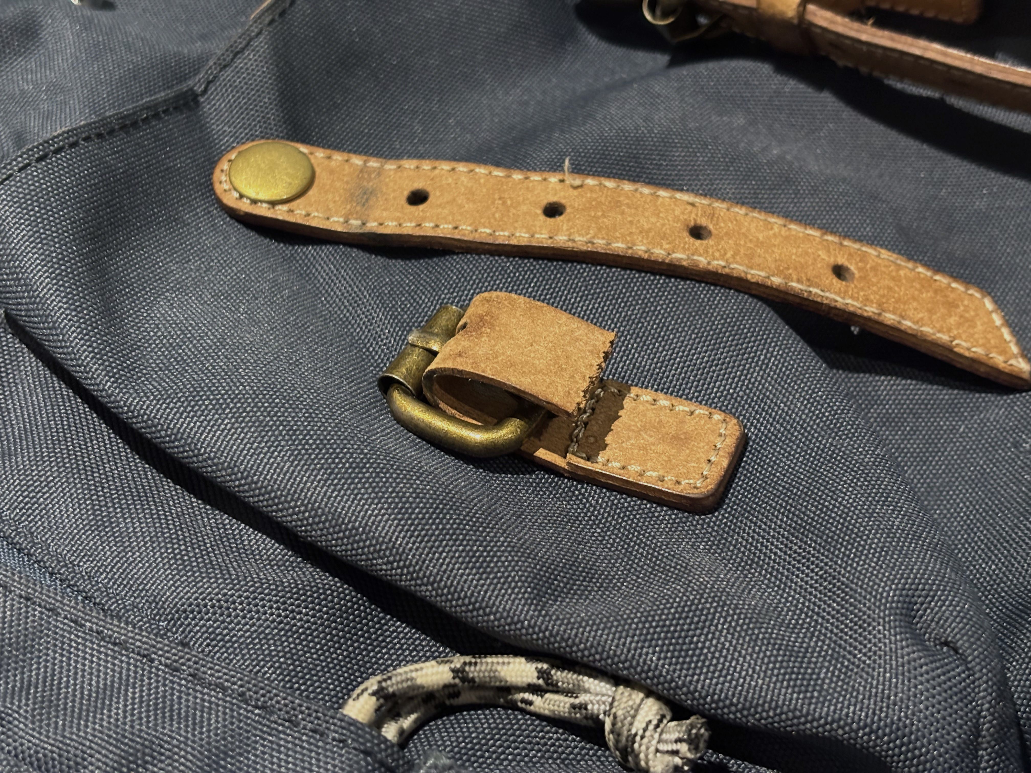 Photo of one of the two front pouch straps broken at the stitches.